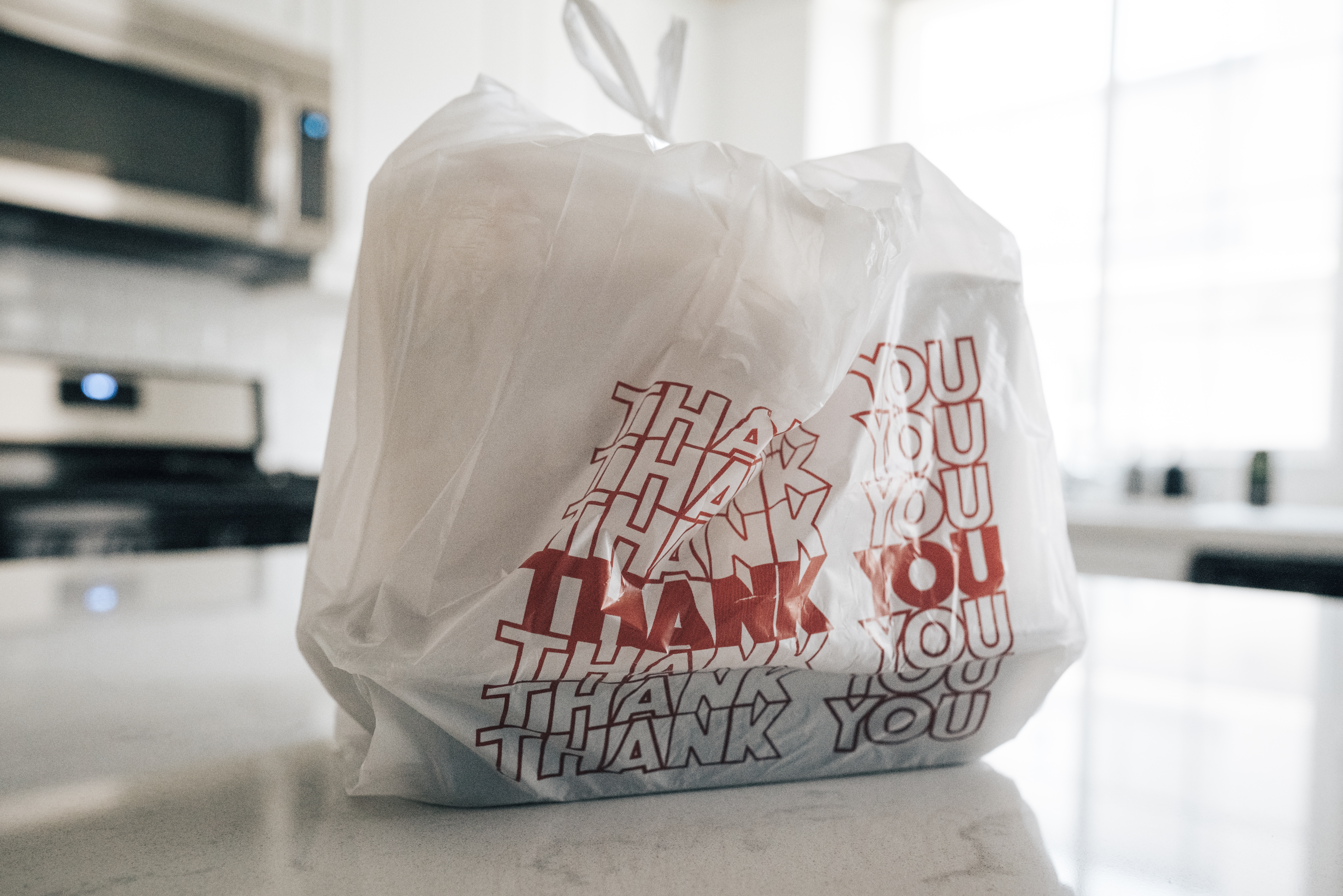 bag of takeout food sitting on kitchen counter