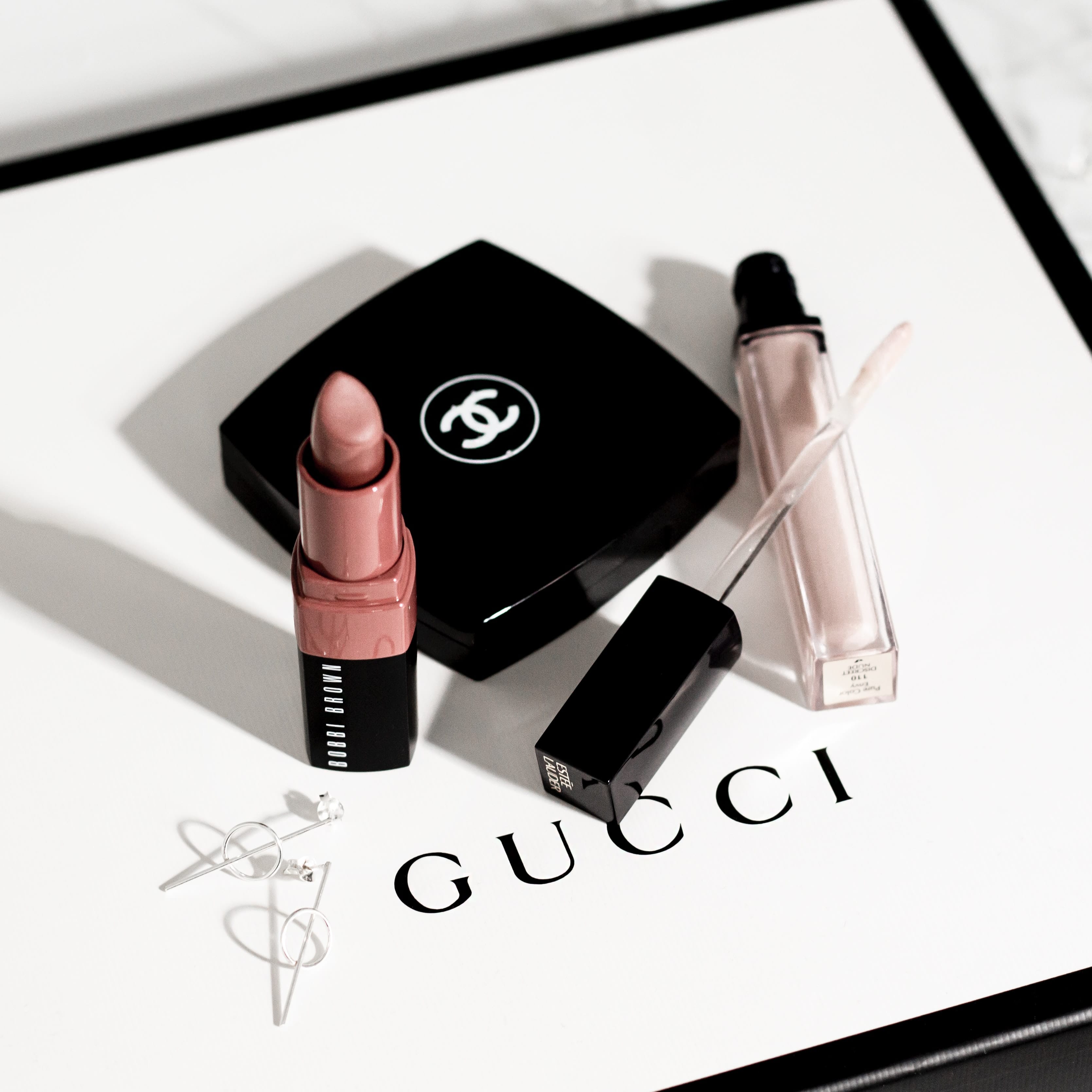 Gucci lipstick and lip gloss on top of packaging