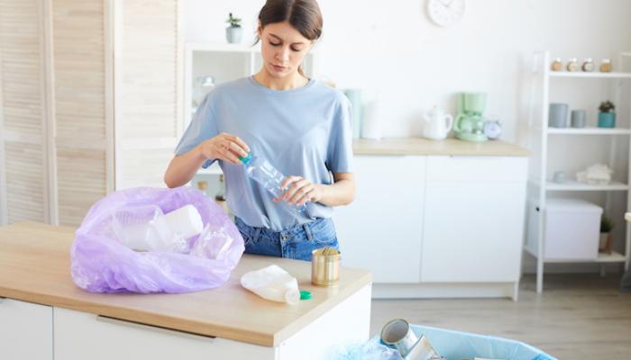 Woman recycling the garbage