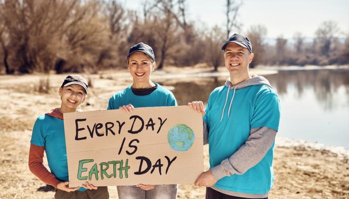 Eco-friendly and Sustainability Supporters Holding a Sign on the Beach that says "Every Day is Earth Day"