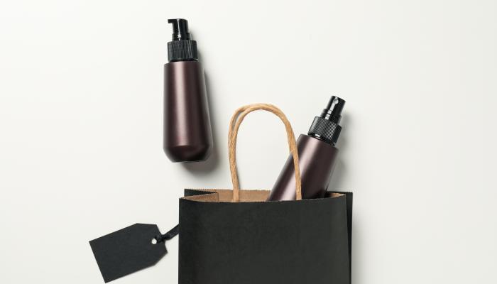 Spray With Minimalist Packaging Coming Out Of A Shopping Bag