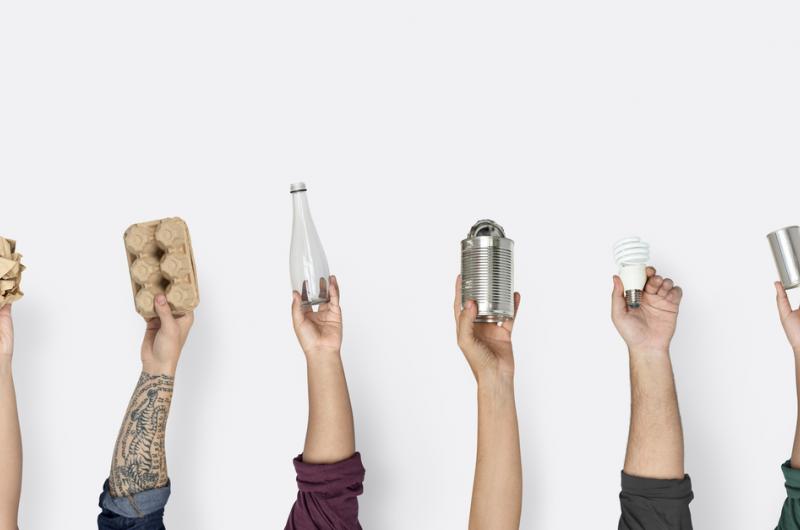 Hands holding up a variety of sustainable packaging solutions
